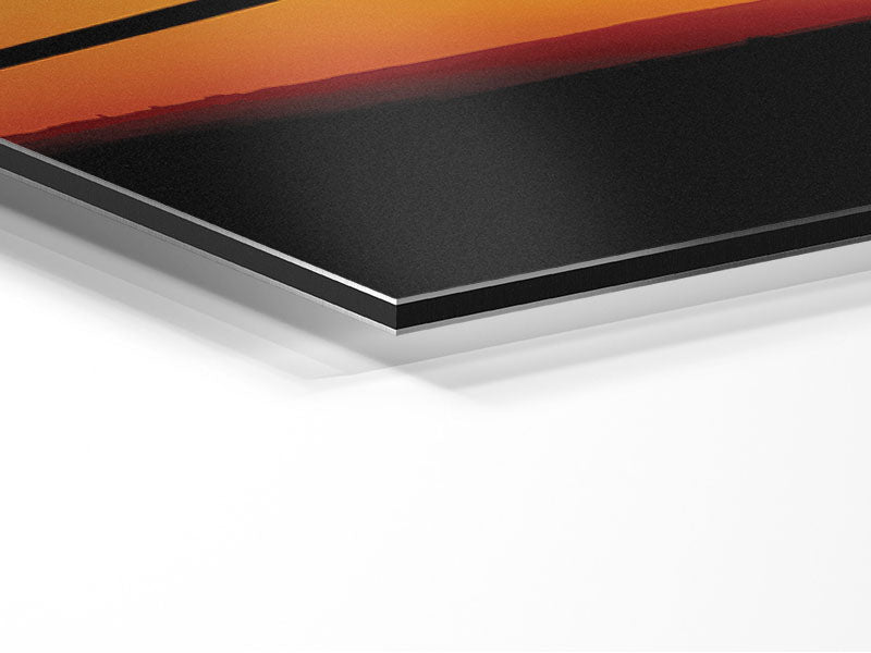 A stunning artwork of an airplane silhouetted against a vibrant sunset, printed on brushed aluminium dibond.