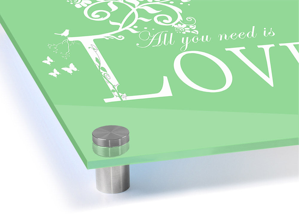 All You Need Is Love Green acrylic print on a wall, showcasing vibrant green colors and modern design.