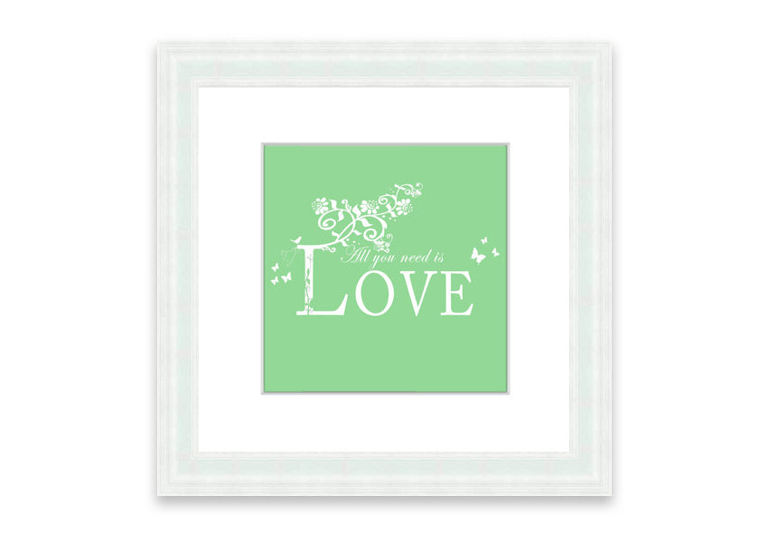 Framed print of 'All You Need Is Love' in green, showcasing vibrant colors and a heartfelt message, ready to hang.