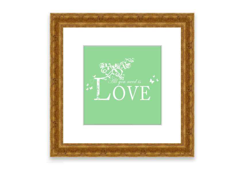 Framed print of 'All You Need Is Love' in green, showcasing vibrant colors and a heartfelt message, ready to hang.