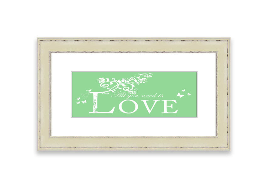 Framed print of 'All You Need Is Love' in green, showcasing vibrant colors and a heartfelt message, ready to hang.