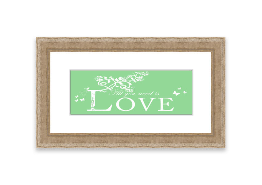 Framed print of 'All You Need Is Love' in green, showcasing vibrant colors and a heartfelt message, ready to hang.