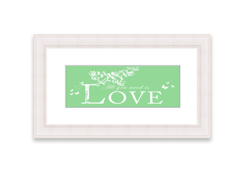 Framed print of 'All You Need Is Love' in green, showcasing vibrant colors and a heartfelt message, ready to hang.