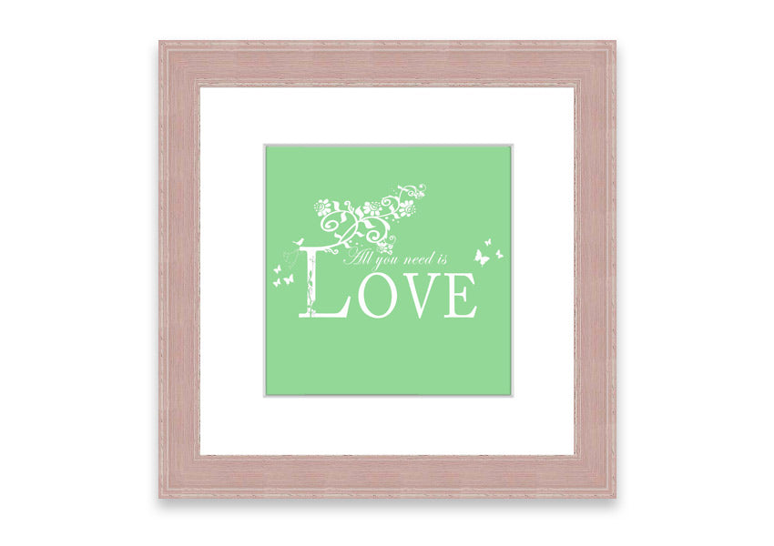 Framed print of 'All You Need Is Love' in green, showcasing vibrant colors and a heartfelt message, ready to hang.