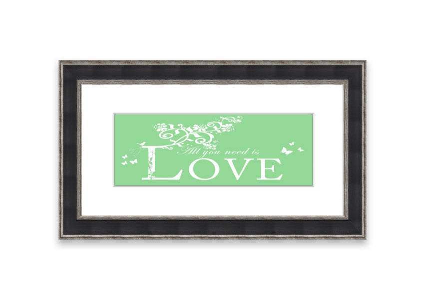 Framed print of 'All You Need Is Love' in green, showcasing vibrant colors and a heartfelt message, ready to hang.