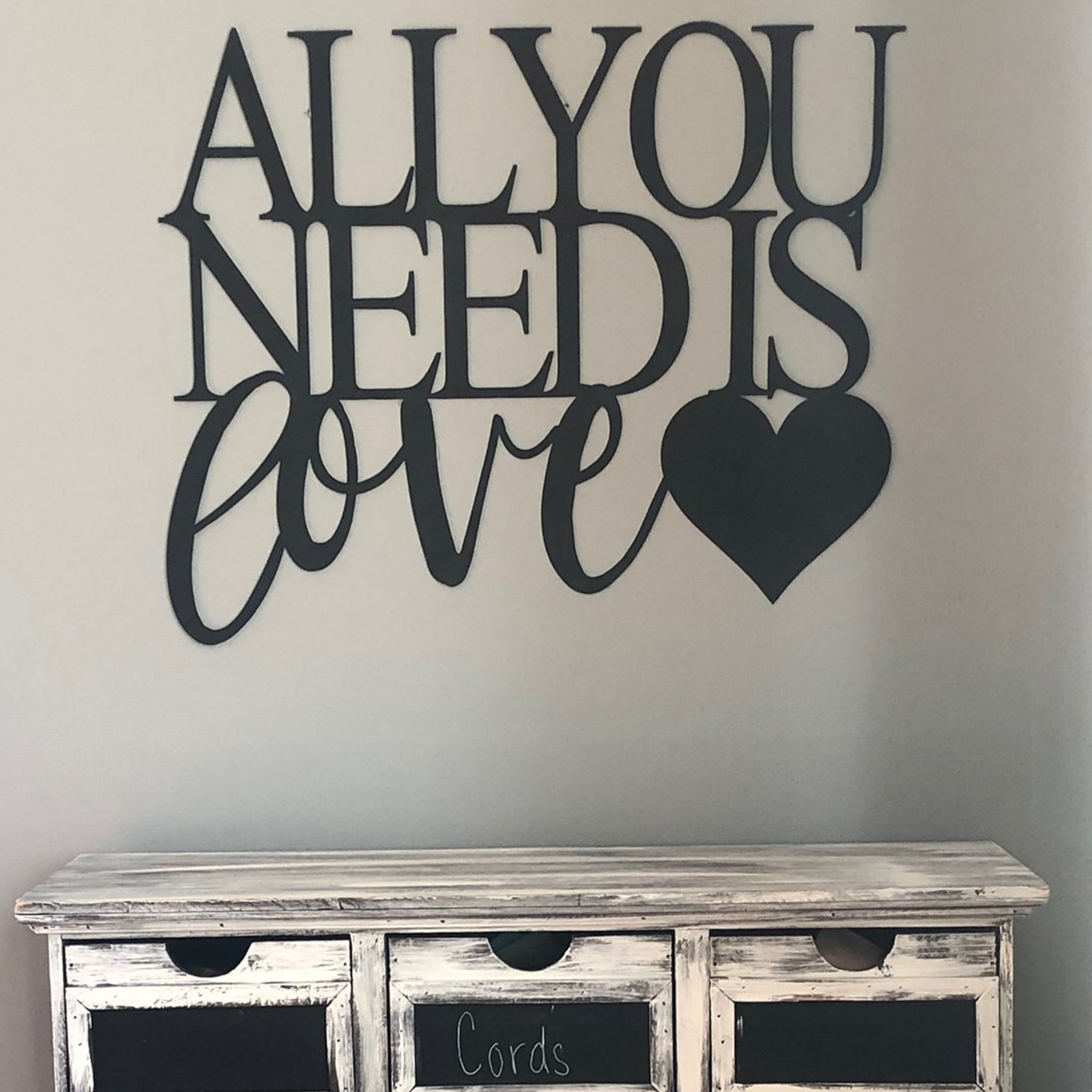 All You Need Is Love metal wall art in low gloss black finish, measuring 26 inches wide and 20 inches tall, perfect for home decor.