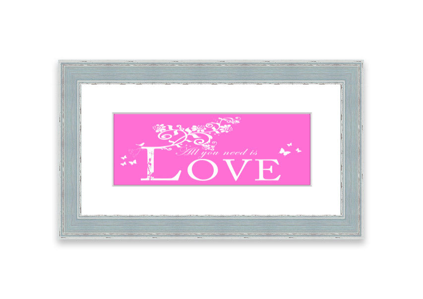 A vibrant pink framed print featuring the phrase 'All You Need Is Love', handmade in the UK, ready to hang.