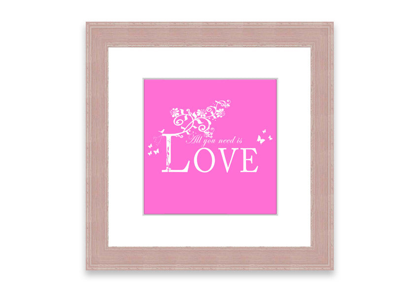 A vibrant pink framed print featuring the phrase 'All You Need Is Love', handmade in the UK, ready to hang.