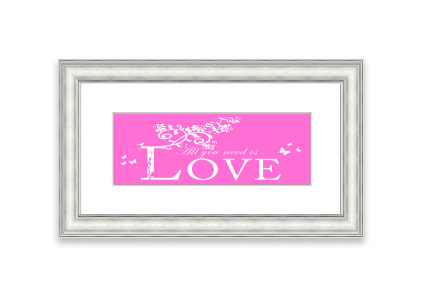 A vibrant pink framed print featuring the phrase 'All You Need Is Love', handmade in the UK, ready to hang.