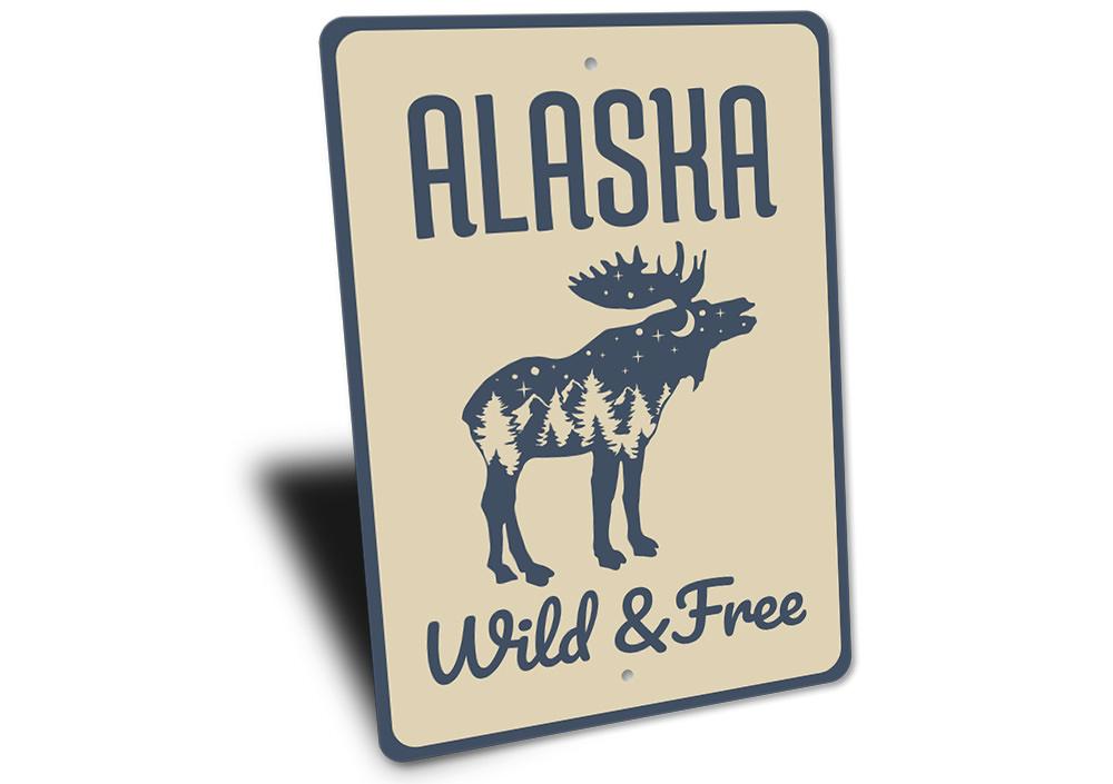 Alaska Wild and Free Sign made of high-quality aluminum, featuring a rustic design perfect for home decor.