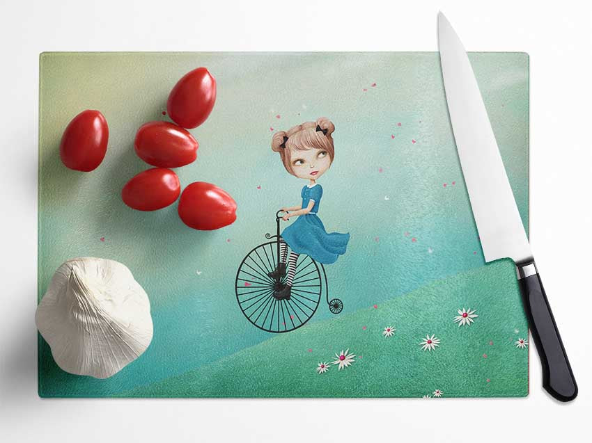 Alice In Wonderland Penny Farthing chopping board made of tempered glass with a chinchilla ripple effect and anti-slip base.