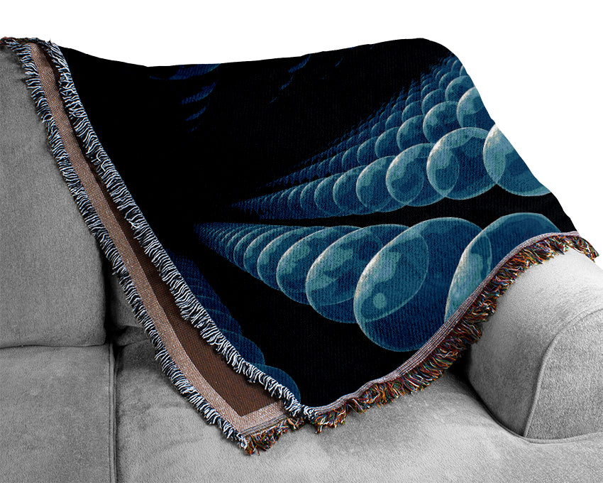 A luxurious blue throw blanket made from 100% cotton, featuring a thermal weave for breathability, draped elegantly over a couch.