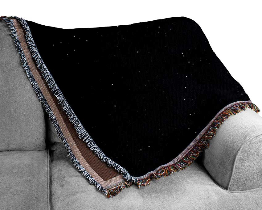 A luxurious Alien Sunrise throw blanket made from 100% cotton, featuring a thermal weave design, draped elegantly over a couch.