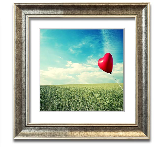 Heart-shaped balloon over field.