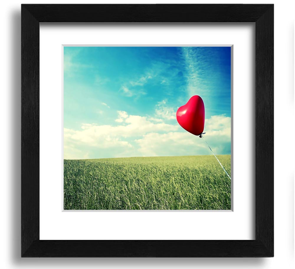 Heart-shaped balloon in field.