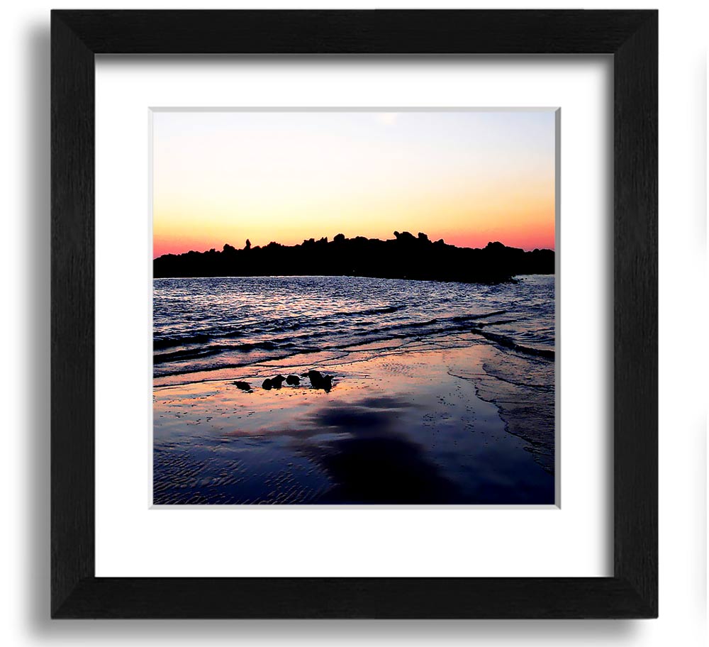 A beautifully framed square print depicting a serene coastal landscape, handmade in the UK, available in various frame colors.