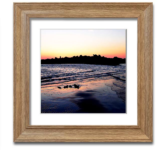 A beautifully framed square print depicting a serene coastal landscape, handmade in the UK, available in various frame colors.