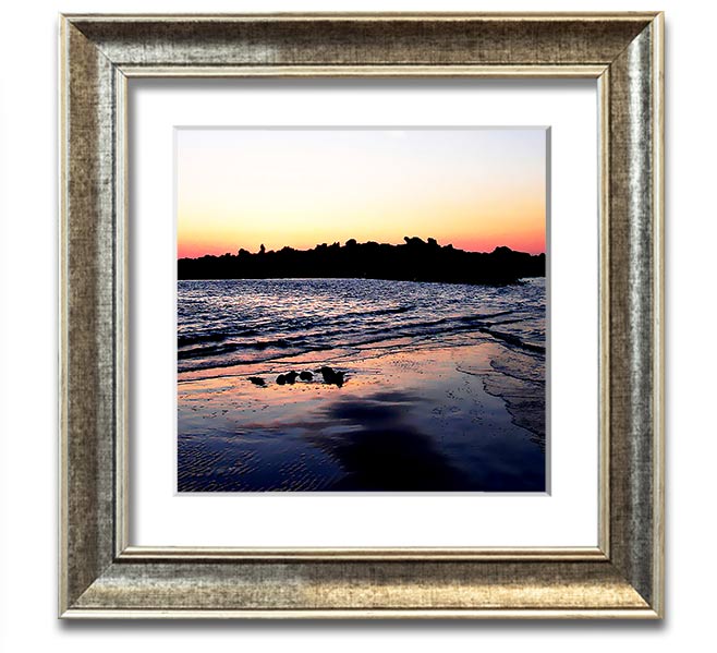 A beautifully framed square print depicting a serene coastal landscape, handmade in the UK, available in various frame colors.