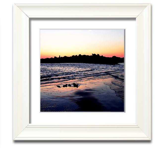 A beautifully framed square print depicting a serene coastal landscape, handmade in the UK, available in various frame colors.