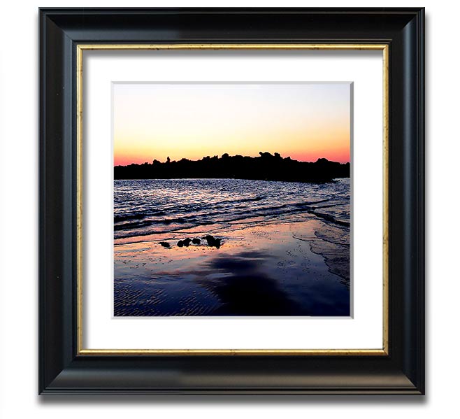 A beautifully framed square print depicting a serene coastal landscape, handmade in the UK, available in various frame colors.