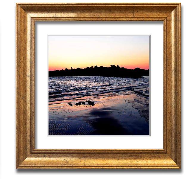 A beautifully framed square print depicting a serene coastal landscape, handmade in the UK, available in various frame colors.