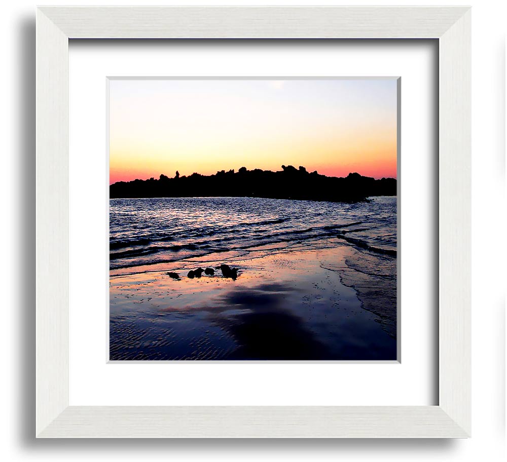 A beautifully framed square print depicting a serene coastal landscape, handmade in the UK, available in various frame colors.