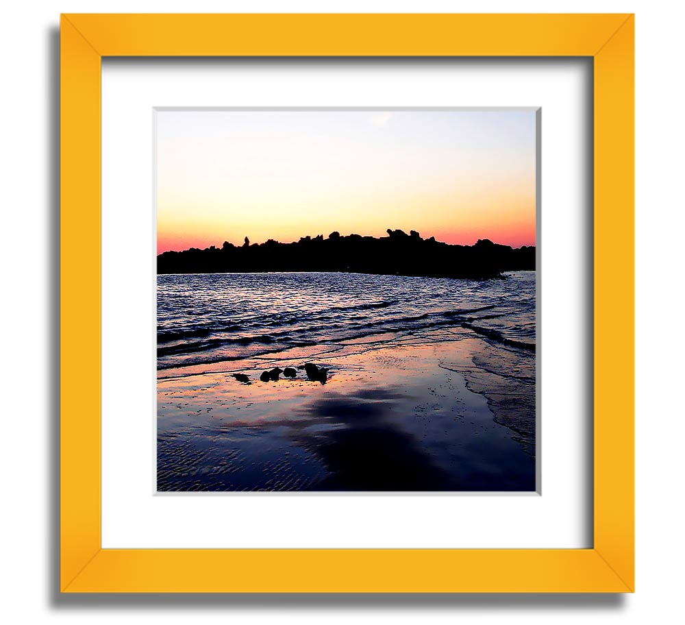 A beautifully framed square print depicting a serene coastal landscape, handmade in the UK, available in various frame colors.