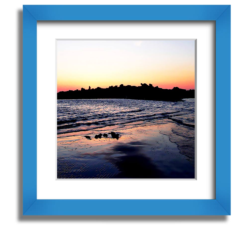 A beautifully framed square print depicting a serene coastal landscape, handmade in the UK, available in various frame colors.