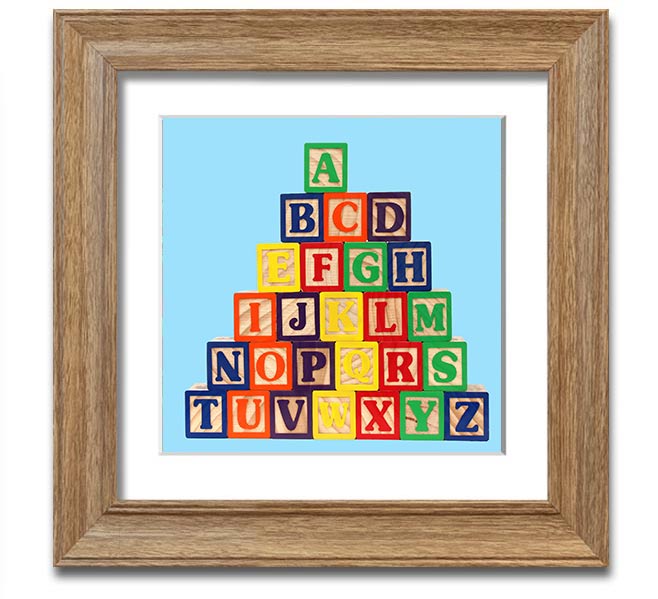 A square framed print featuring baby blue alphabet blocks, perfect for nursery decor.