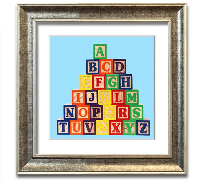 A square framed print featuring baby blue alphabet blocks, perfect for nursery decor.