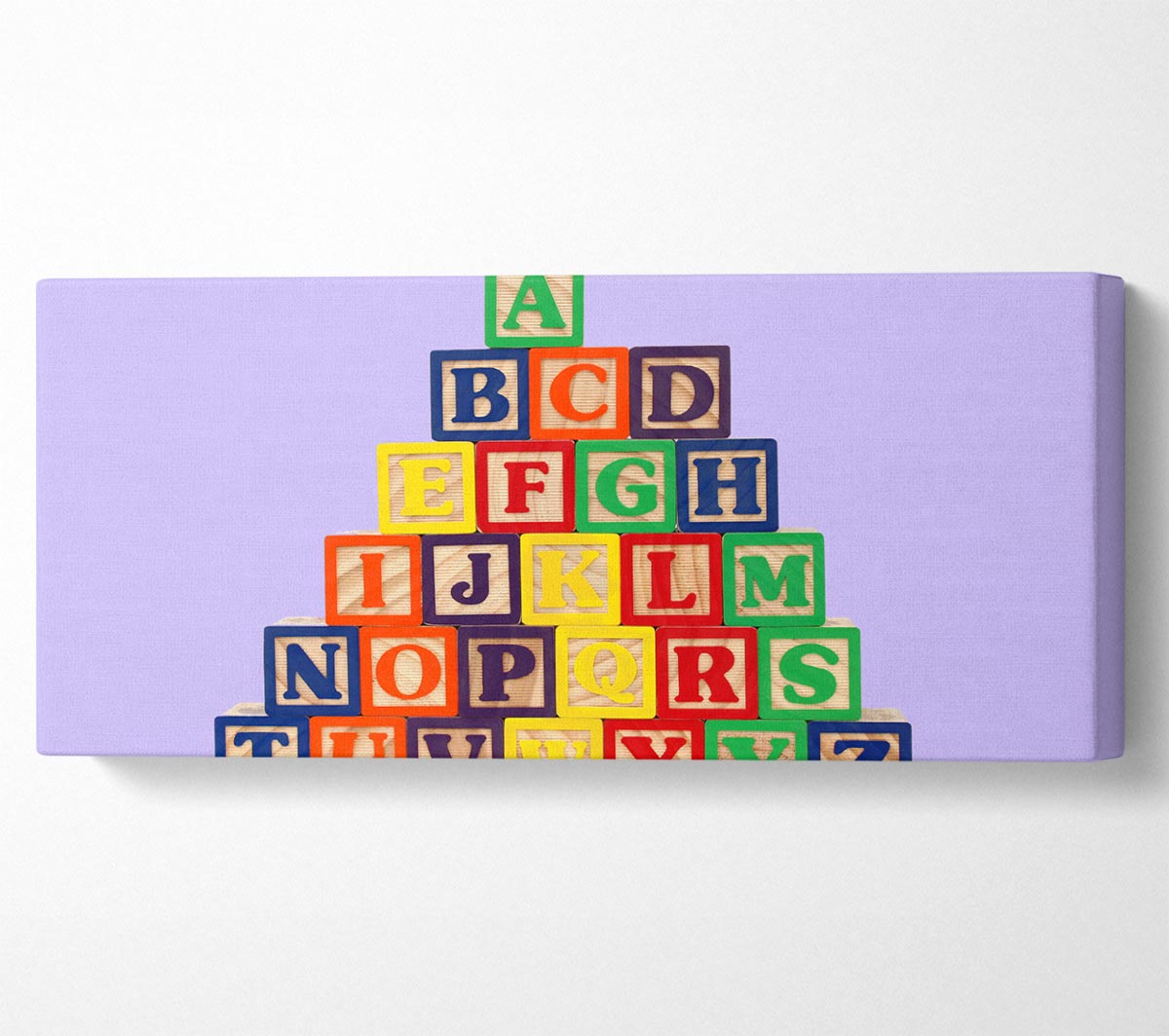 Alphabet Blocks Lilac canvas art featuring colorful letters on a lilac background, mounted on a sturdy box frame, ready to hang.