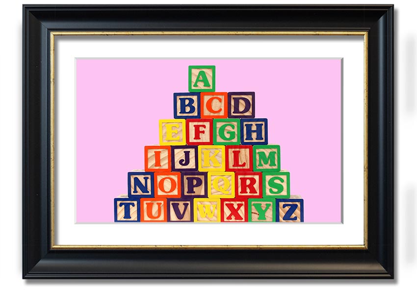 A charming pink framed print featuring colorful alphabet blocks, perfect for nursery decor.