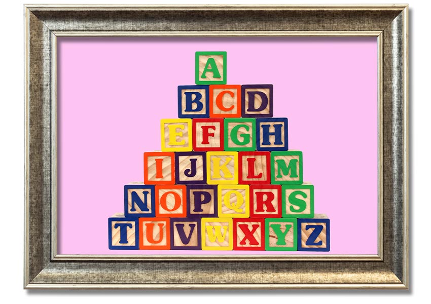 A charming pink framed print featuring colorful alphabet blocks, perfect for nursery decor.