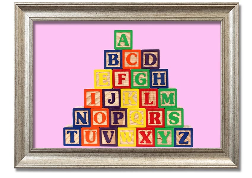 A charming pink framed print featuring colorful alphabet blocks, perfect for nursery decor.