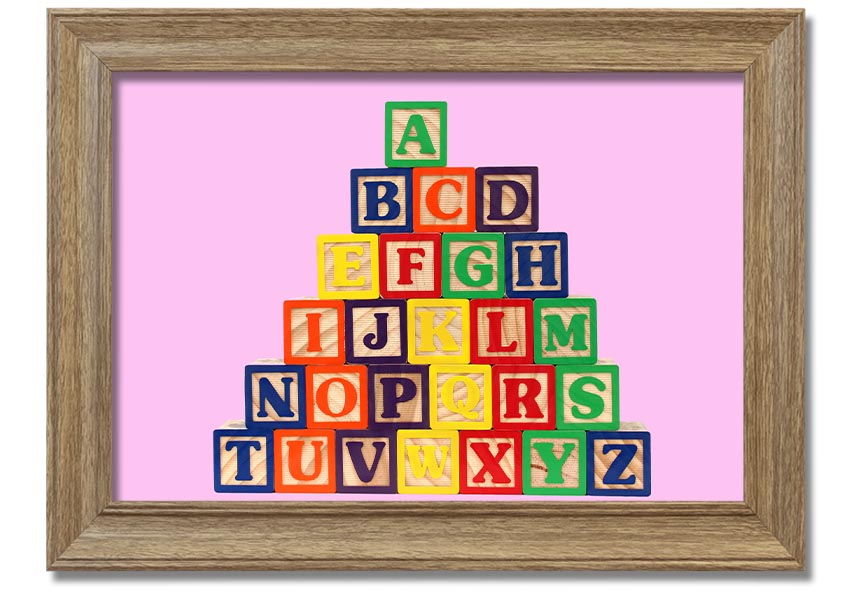 A charming pink framed print featuring colorful alphabet blocks, perfect for nursery decor.