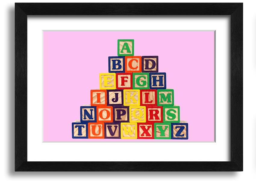 A charming pink framed print featuring colorful alphabet blocks, perfect for nursery decor.