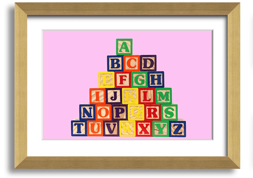 A charming pink framed print featuring colorful alphabet blocks, perfect for nursery decor.