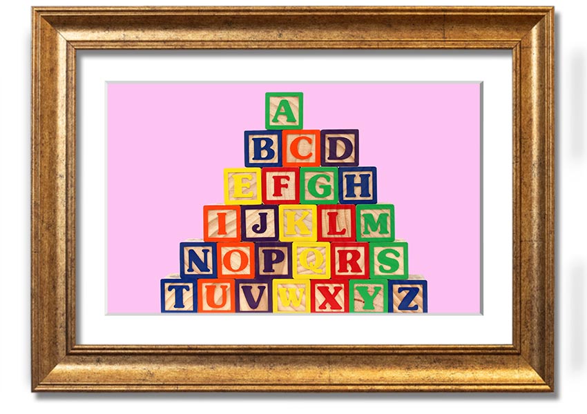 A charming pink framed print featuring colorful alphabet blocks, perfect for nursery decor.