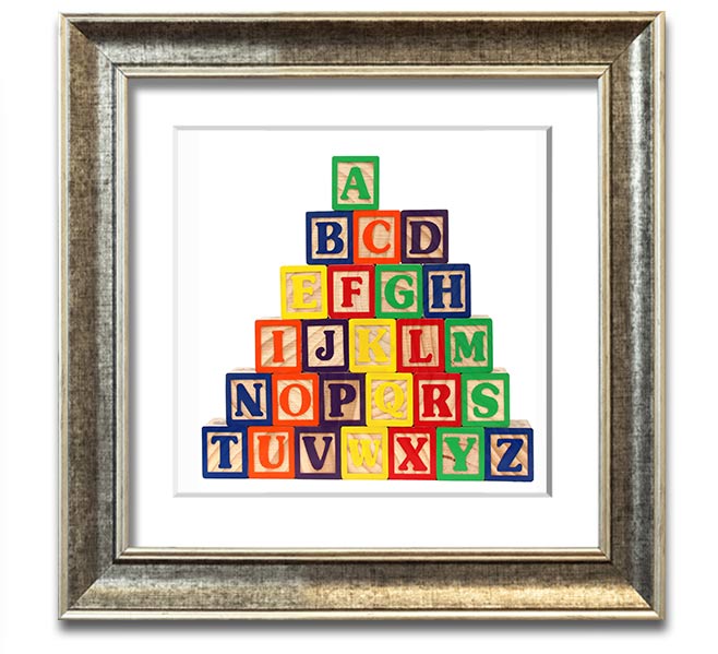 A stylish white framed print featuring colorful alphabet blocks, perfect for children's decor.