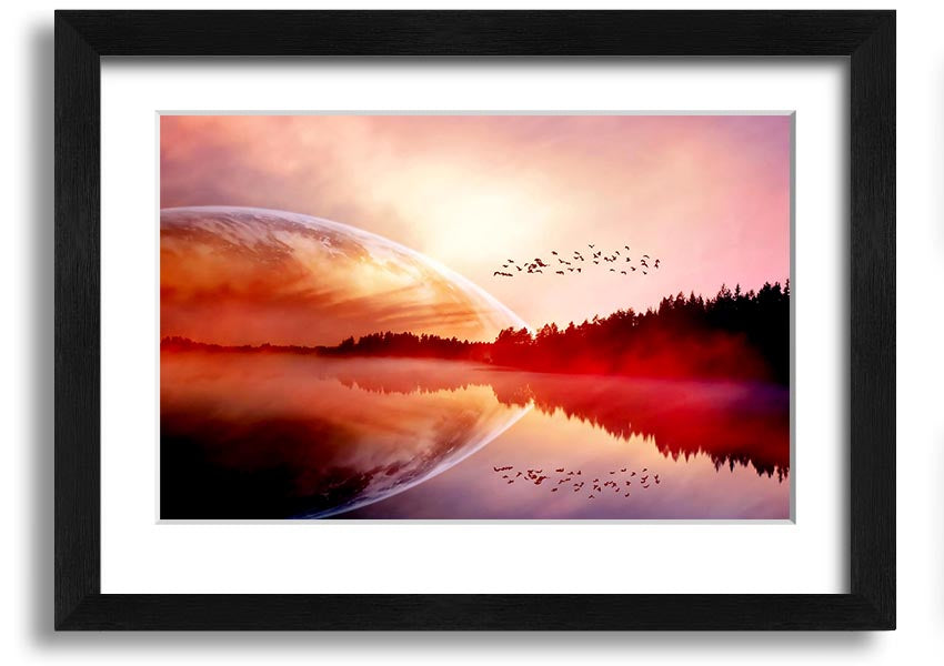 A beautifully framed print of a serene sunrise over a tranquil lake, showcasing vibrant colors and a peaceful landscape.