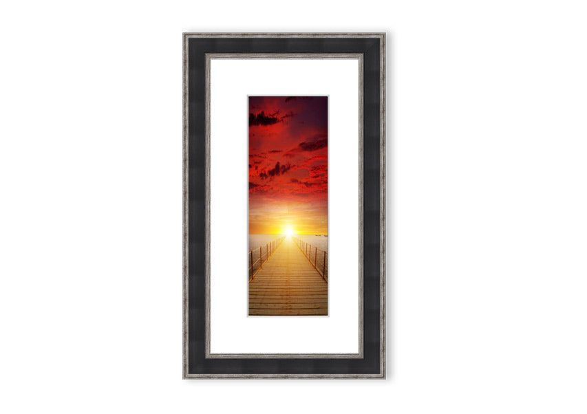 Framed print of a sunset over a boardwalk, showcasing vibrant colors and serene scenery, available in multiple frame options.