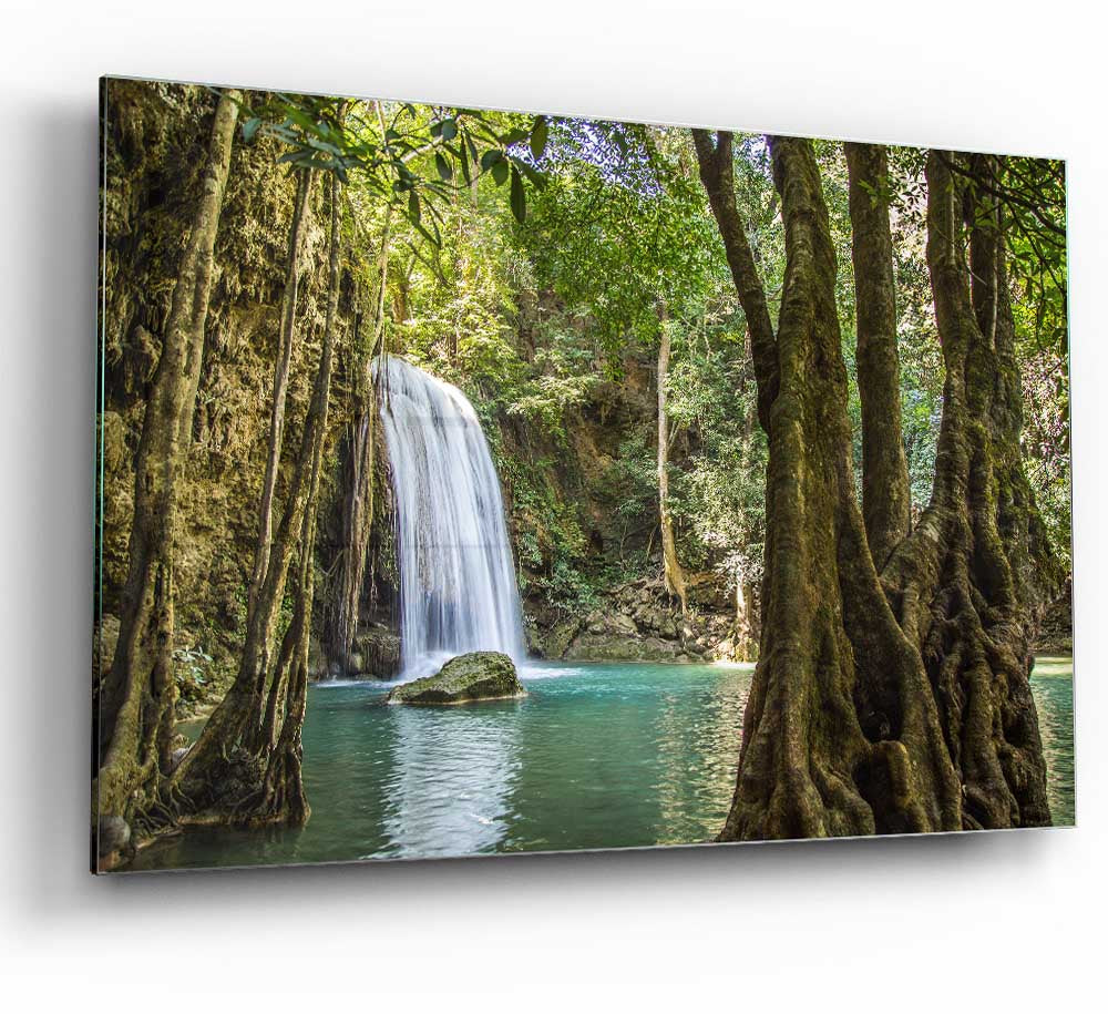 A vibrant glass print depicting a waterfall in the Amazon jungle, surrounded by lush greenery, perfect for modern home decor.