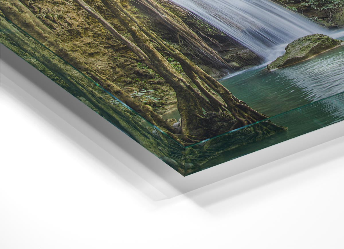 A vibrant glass print depicting a waterfall in the Amazon jungle, surrounded by lush greenery, perfect for modern home decor.