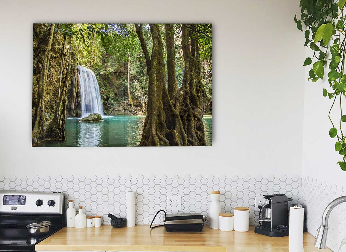 A vibrant glass print depicting a waterfall in the Amazon jungle, surrounded by lush greenery, perfect for modern home decor.