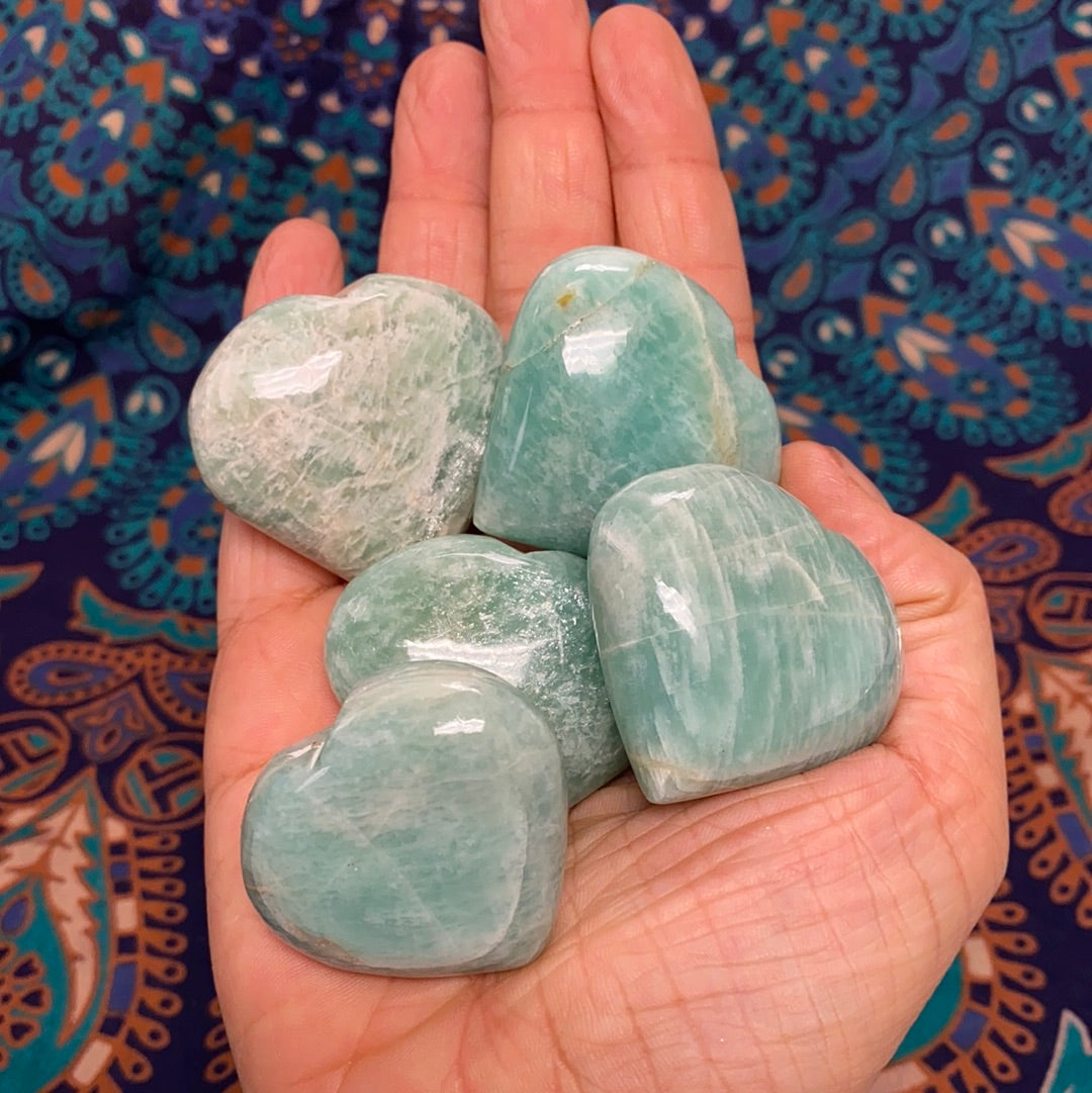 A beautiful Amazonite Heart (S) gemstone, showcasing its unique pale aqua color and natural shape, perfect for healing and decorative purposes.