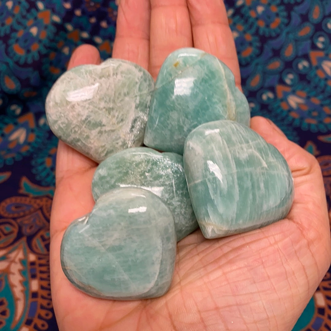 A beautiful Amazonite Heart (S) gemstone, showcasing its unique pale aqua color and natural shape, perfect for healing and decorative purposes.