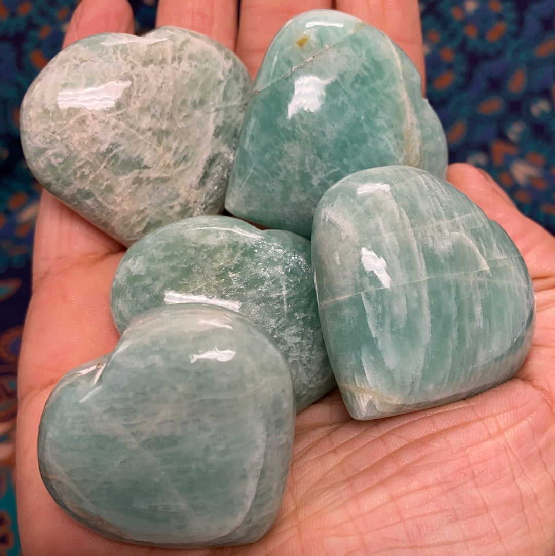 A beautiful Amazonite Heart (S) gemstone, showcasing its unique pale aqua color and natural shape, perfect for healing and decorative purposes.