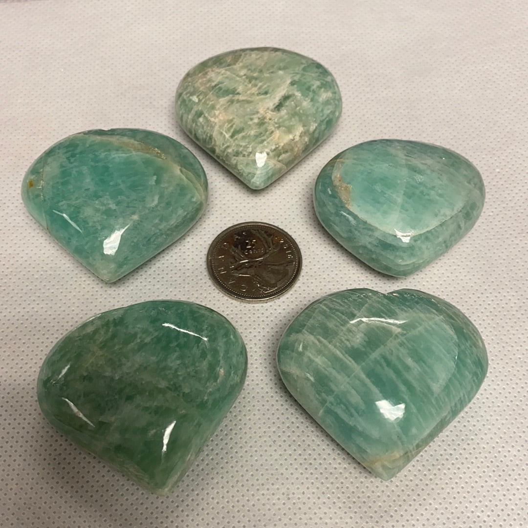 A beautiful Amazonite Heart (S) gemstone, showcasing its unique pale aqua color and natural shape, perfect for healing and decorative purposes.