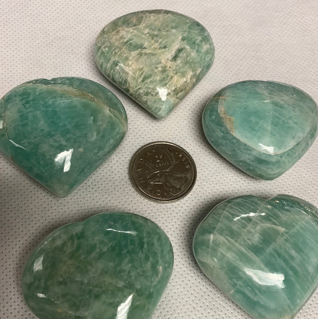 A beautiful Amazonite Heart (S) gemstone, showcasing its unique pale aqua color and natural shape, perfect for healing and decorative purposes.