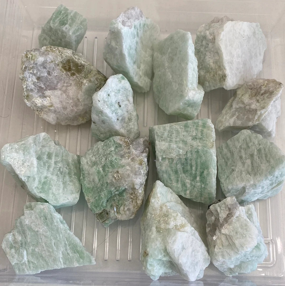 A collection of Amazonite Rough Cut stones showcasing unique shapes and pale aqua colors, perfect for jewelry and ceramics.